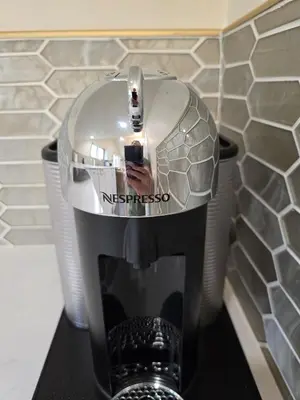 a person taking a picture of a mixer in a bathroom at Luxury Living in the city in Denver