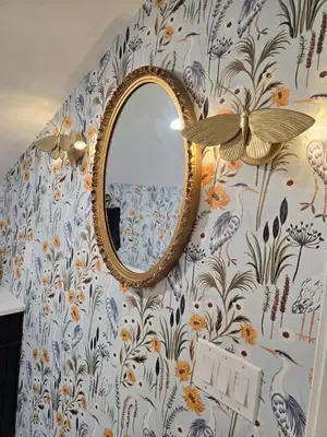 a mirror on a wall with a floral wallpaper at Luxury Living in the city in Denver