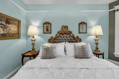 a bedroom with a large white bed with two lamps at Historic Cap Hill Gem Prime Location Walkable in Denver