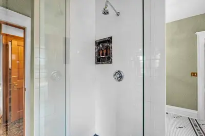 a shower with a glass door in a bathroom at Historic Cap Hill Gem Prime Location Walkable in Denver
