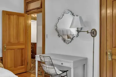 a room with a desk and a mirror on the wall at Historic Cap Hill Gem Prime Location Walkable in Denver