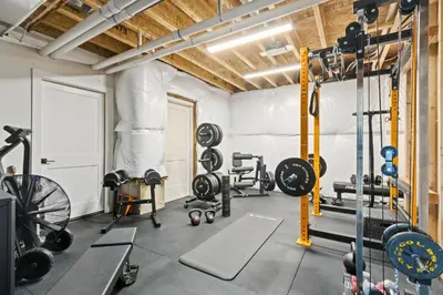 a gym with weights and equipment in a building at Bridle Ridge Retreat - Modern Comfort, Open Views in Timnath