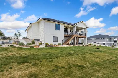 a large white house with a large yard at Bridle Ridge Retreat - Modern Comfort, Open Views in Timnath