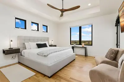 a white bedroom with a bed and a couch at Bridle Ridge Retreat - Modern Comfort, Open Views in Timnath