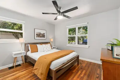 a bedroom with a bed and a ceiling fan at Urban Nest - Garage, Sunroom & Fenced Yard in Fort Collins