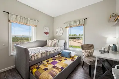 a living room with a bed and a desk and window at Wright House - Country Retreat with Spa, EV & Garage in Loveland
