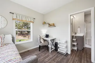 a bedroom with a bed and a desk and a window at Wright House - Country Retreat with Spa, EV & Garage in Loveland
