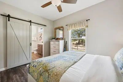 a bedroom with a bed and a ceiling fan at Wright House - Country Retreat with Spa, EV & Garage in Loveland