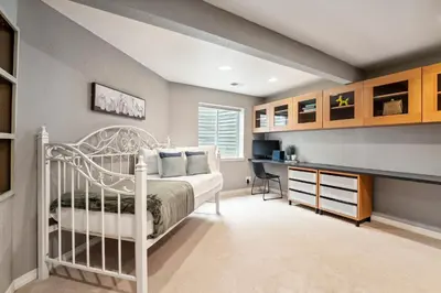a bedroom with a white bed and a desk at Parkside Retreat - 2 Suites, Office, Garage in Fort Collins