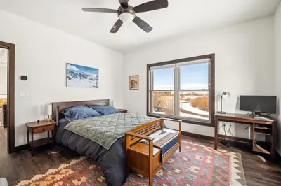 a bedroom with a bed and a desk and a tv at 4br Mountain View Home - 5 Minutes To Granby Ranch in Granby
