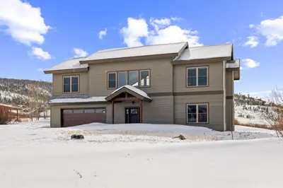 a house in the snow in front at 4br Mountain View Home - 5 Minutes To Granby Ranch in Granby