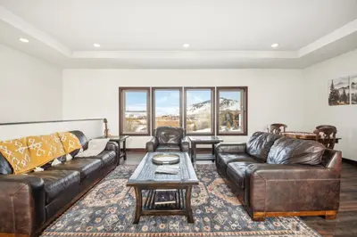 a living room with leather couches and a coffee table at 4br Mountain View Home - 5 Minutes To Granby Ranch in Granby