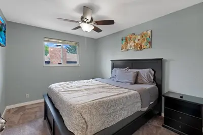a bedroom with a bed with a ceiling fan at Arvada Retreat + 6 BD + Movie Theater in Arvada