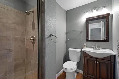 a bathroom with a toilet and a sink and a shower at Arvada Retreat + 6 BD + Movie Theater in Arvada
