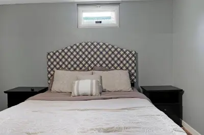 a bedroom with a bed with two night stands and a window at Arvada Retreat + 6 BD + Movie Theater in Arvada