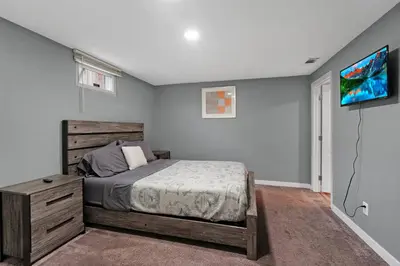 a bedroom with a bed and a flat screen tv at Arvada Retreat + 6 BD + Movie Theater in Arvada