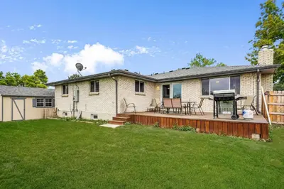 a house with a deck with a grill at Arvada Retreat + 6 BD + Movie Theater in Arvada