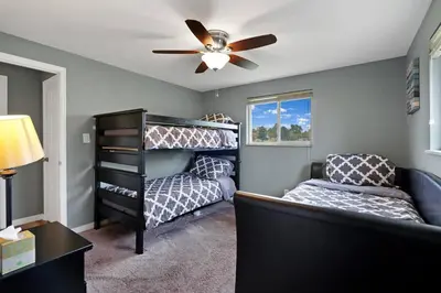 a bedroom with two beds and a ceiling fan at Arvada Retreat + 6 BD + Movie Theater in Arvada