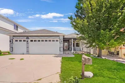 a house with a garage and a driveway at HUGE Downtown Getaway! w/Hot Tub in Arvada