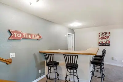 a bar in a room with stools and a to the bar sign at HUGE Downtown Getaway! w/Hot Tub in Arvada