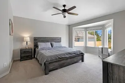 a bedroom with a bed and a ceiling fan at HUGE Downtown Getaway! w/Hot Tub in Arvada
