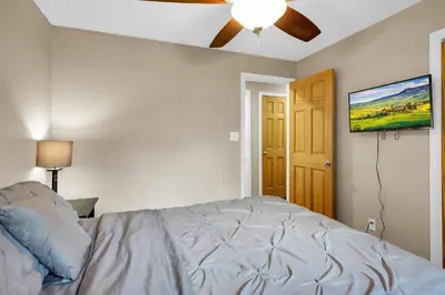 a bedroom with a bed and a flat screen tv at Huge Arvada Retreat! Quiet Area in Arvada