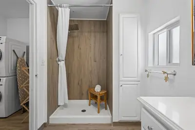 a bathroom with a shower with a white shower curtain at Heated Pool BBQ Cabana Gardens in Denver