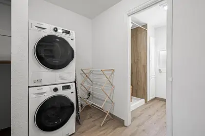 a laundry room with two washing machines in a room at Heated Pool BBQ Cabana Gardens in Denver