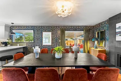 a dining room with a table and chairs at Theater, Hot Tub, Mini Golf, Luxe Fun House in Centennial