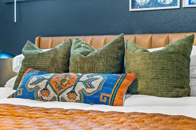 a group of pillows on a bed with at Theater, Hot Tub, Mini Golf, Luxe Fun House in Centennial