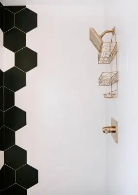 a bathroom with a black and white tiled wall at Olde Town Ambler A Distinctive Walkable Retreat in Arvada