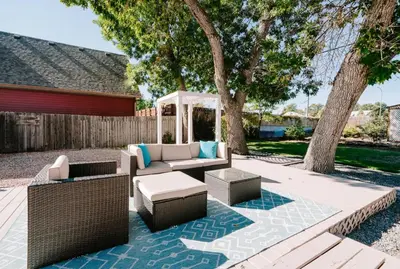 a patio with a couch and a gazebo at Olde Town Ambler A Distinctive Walkable Retreat in Arvada