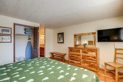 a bedroom with a bed and a tv and a dresser at 2 Mi to Winter Park Resort Mtn-View Haven! in Winter Park