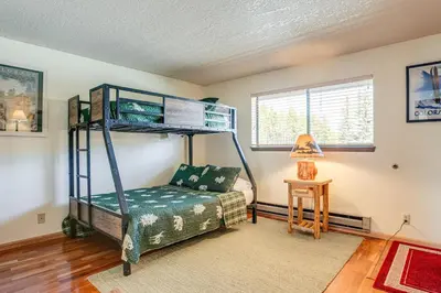 a bedroom with a bunk bed and a table at 2 Mi to Winter Park Resort Mtn-View Haven! in Winter Park