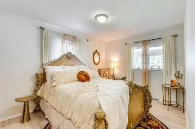 a bedroom with a large bed with a large window at Near Shops and Eats Elegant Home in Wheat Ridge! in Wheat Ridge