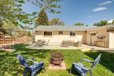 a yard with two chairs and a flower pot at Near Shops and Eats Elegant Home in Wheat Ridge! in Wheat Ridge