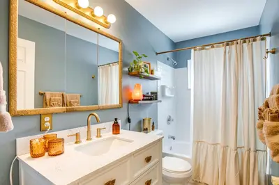 a bathroom with a sink and a toilet and a mirror at Near Shops and Eats Elegant Home in Wheat Ridge! in Wheat Ridge