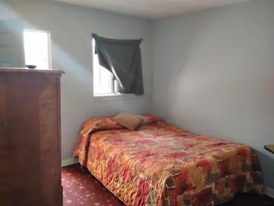 a small bedroom with a bed and a window at Hotel O Englewood-South Denver CO in Englewood