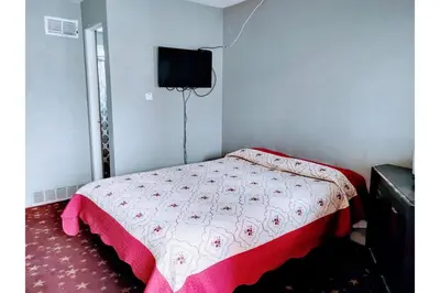 a small bedroom with a bed and a television at Hotel O Englewood-South Denver CO in Englewood