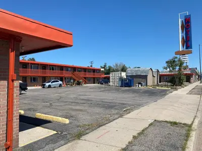 an empty parking lot in front of a building at Hotel O Englewood-South Denver CO in Englewood