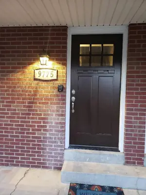 a black front door of a brick house with a sign at West Denver Home 8 Beds! Game Room in Lakewood