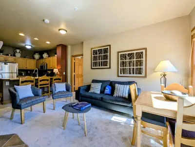 a living room with a couch and a table at Hidden River Lodge 5965 by SummitCove Lodging in Keystone