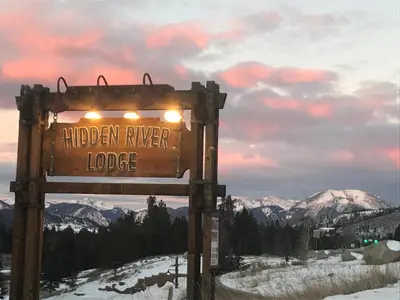 a sign for the hidden river lodge in the mountains at Hidden River Lodge 5965 by SummitCove Lodging in Keystone