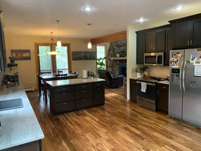 a kitchen with wooden floors and stainless steel appliances at Your Mountain Retreat in Loveland