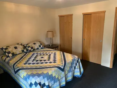 a bedroom with a bed and a lamp on a table at Your Mountain Retreat in Loveland