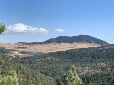a view of a mountain with trees and a lake at Your Mountain Retreat in Loveland