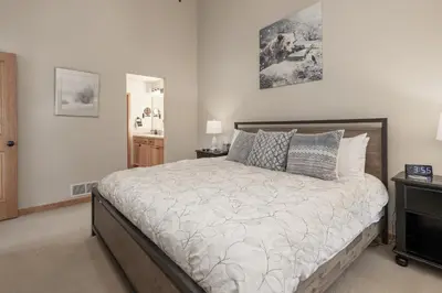 a bedroom with a large bed with pillows at 130 Discovery Court at Rendezvous home in Fraser