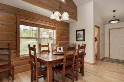 a dining room with a wooden table and chairs at 130 Discovery Court at Rendezvous home in Fraser