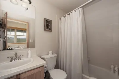 a bathroom with a toilet and a sink and a shower at 130 Discovery Court at Rendezvous home in Fraser
