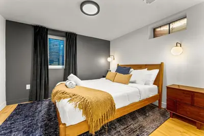a bedroom with a large bed and a window at Arvada Hotspot Modern Vibes Sauna and Games in Arvada